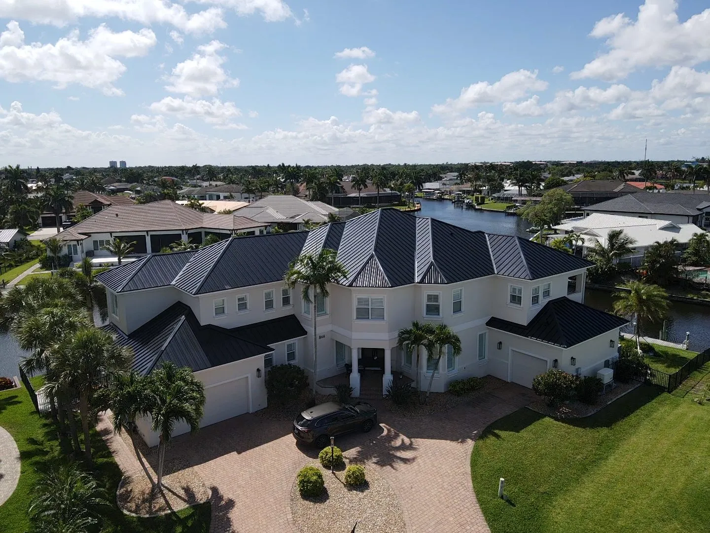 Black standing seam metal roof on a Florida waterfront home