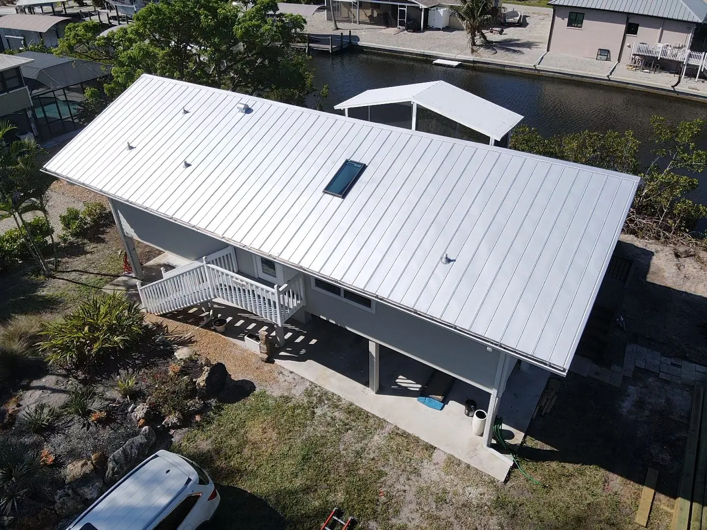 Silver standing seam metal roof on a Florida stilt home