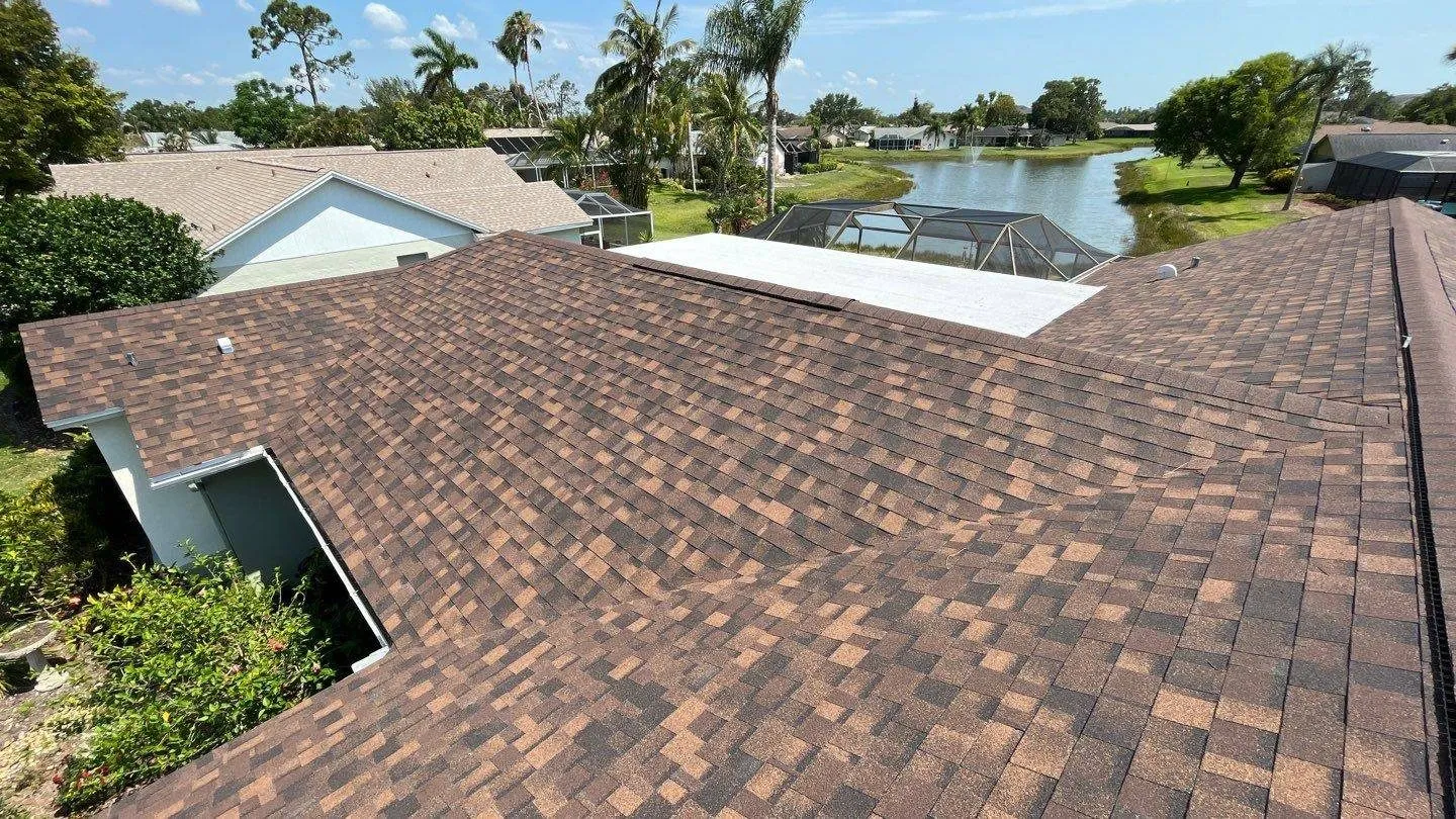 New brown shingle roof with a lake view