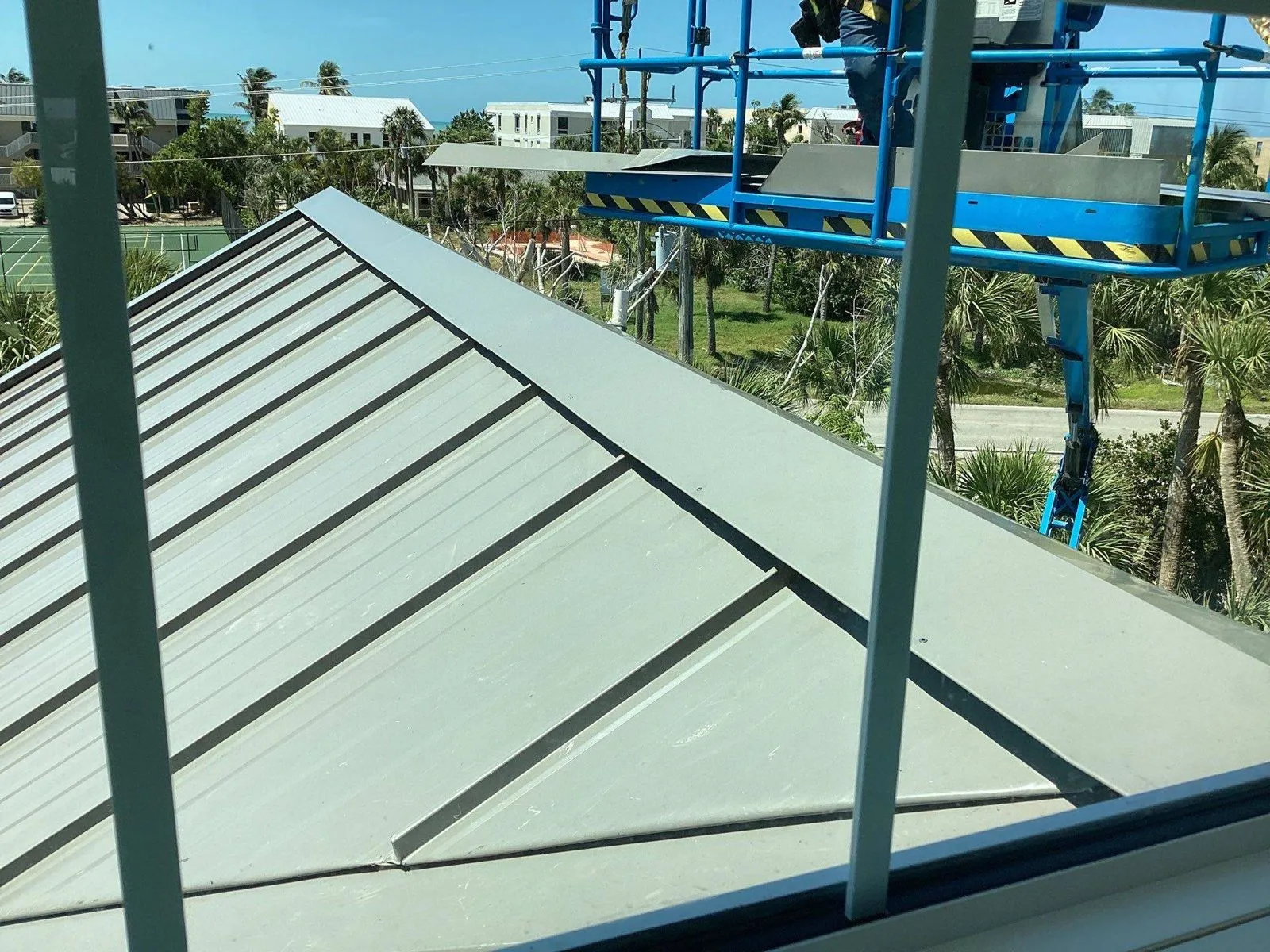 Standing seam metal roof installation on a commercial building