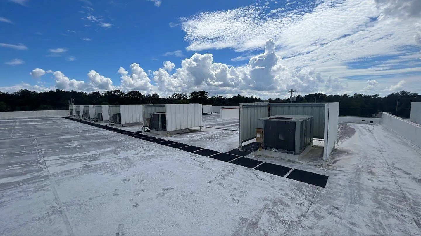 Aging commercial flat roof with rooftop HVAC units